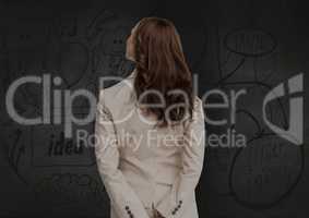 Businesswoman looking at start up icons against digitally generated background