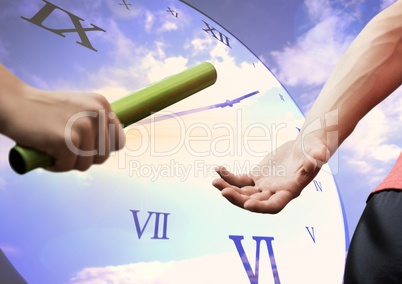Athletes passing the baton against digitally generated clock in background