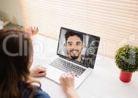 Woman having a video call with her colleague on laptop