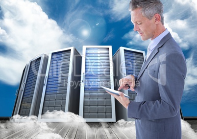 Digital composite image of businessman using digital tablet against server tower