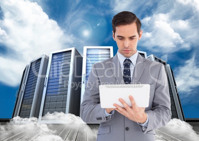 Businessman using digital tablet against office building in background