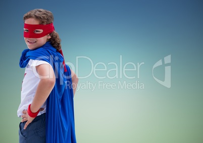 Portrait of kid in blue cape and red mask standing with hand on hip