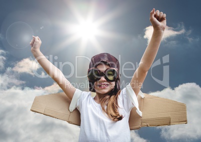 Portrait of excited smiling kid pretending to be a pilot against bright sunlight background
