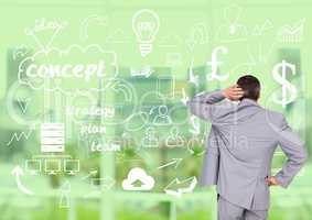 Businessman looking at start up icons against digitally generated background