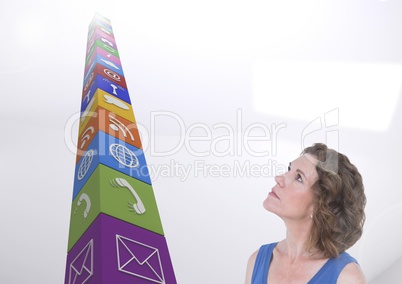 Woman looking at application icons against white background