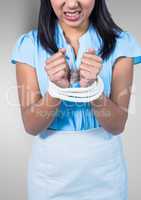 Businesswoman hands tied up with rope