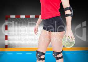 Mid section of female player holding handball