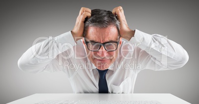 Confused businessman sitting on his desk