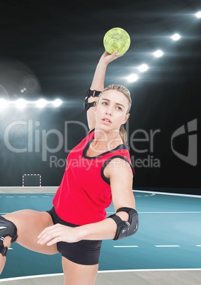 Female handball player throwing ball at handball court