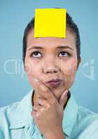 Confused woman with blank sticky note on her forehead
