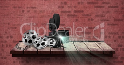 Film projector with reel placed on table against red bricked wall