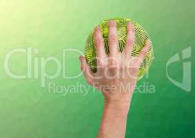 Hand of athlete holding ball against textured green background