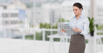 Businesswoman holding a clipboard at office