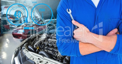 Mechanic holding lug wrench in car repair garage