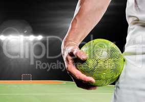 Male athlete holding handball in stadium