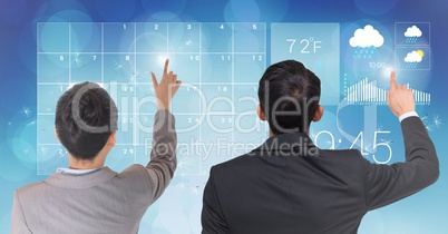 Rear view of businesspeople touching digital screen