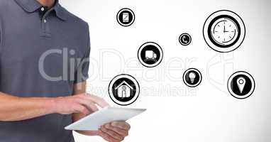 Man using digital tablet with various icons in background