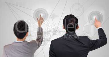 Rear view of businessman and woman touching digital screen