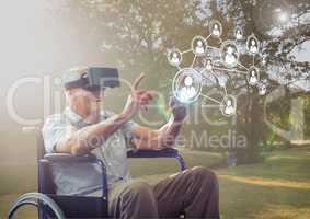 Senior man sitting on wheelchair using virtual reality headset and network connecting icons