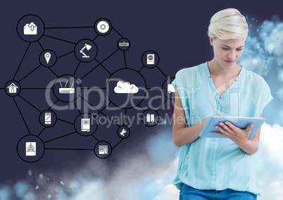 Woman using digital tablet against interface of connecting icons in the background