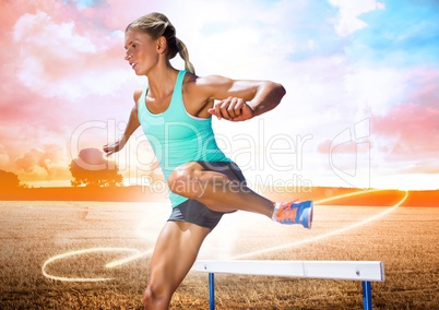 Athlete running over hurdle