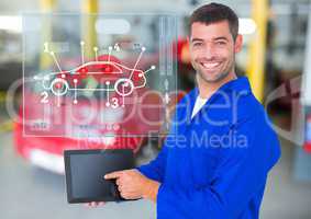 Mechanic using digital tablet against car mechanics interface in background