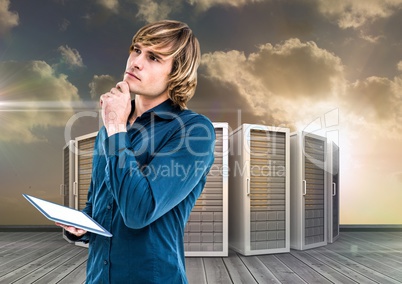 Digital composite image of businessman using digital tablet against server tower