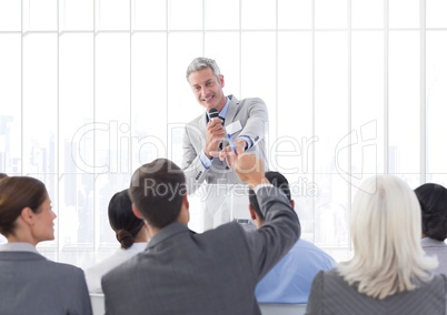 Businessman giving a speech in conference hall