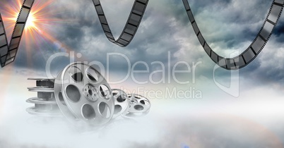 Film reels against sky in background