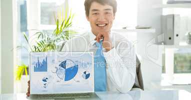 Businessman with laptop displaying graph charts on screen