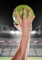 Close-up of hand holding ball against goal net