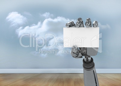 Robot hand holding blank placard against cloudy sky