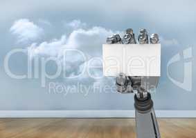 Robot hand holding blank placard against cloudy sky