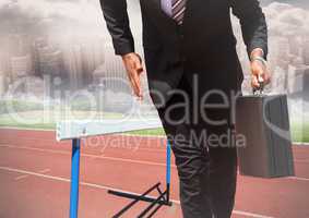 Businessman holding briefcase and running on race track