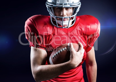 American football player holding rugby ball