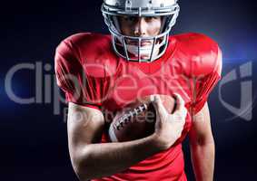 American football player holding rugby ball