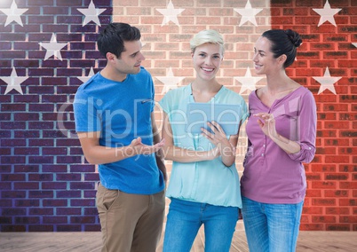 Executives discussing over digital tablet against brick wall with star shapes