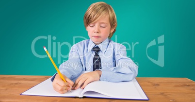 School boy doing homework at desk