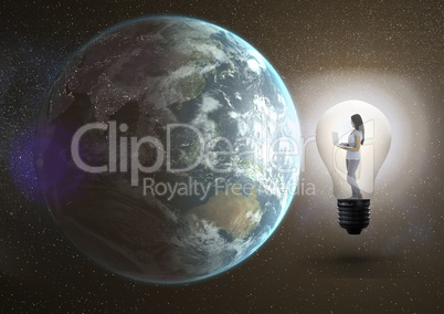 Digital composite image of a girl using laptop in the electric bulb