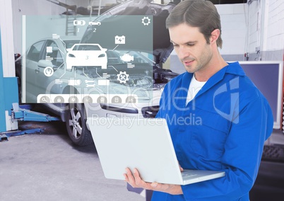 Mechanic using laptop against car mechanics interface in background