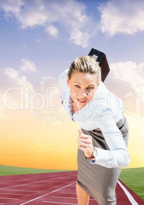 Businesswoman with briefcase running on race track