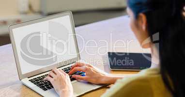 Woman working on laptop at desk