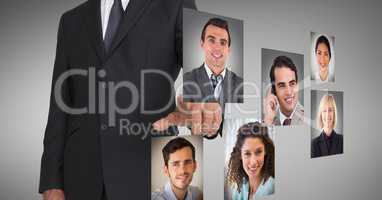 Businessman touching profile pictures of business executives