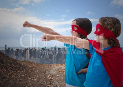 Kids in superhero costume pretending to fly against cityscape