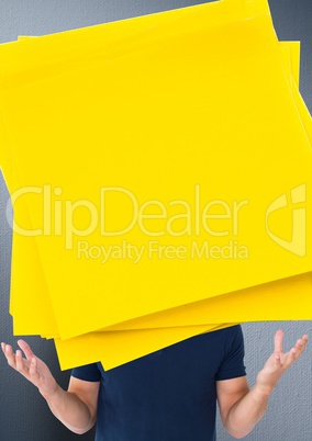 Man with large yellow sticky notes in front of face