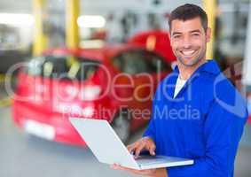 Mechanic using laptop in garage