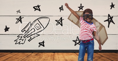 Kid pretending to be a pilot against stars and rocket drawn on background
