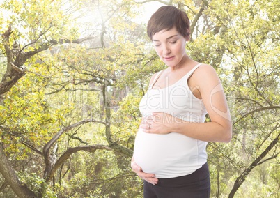 Pregnant woman standing against Greenery