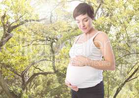 Pregnant woman standing against Greenery