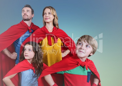 Super family wearing red cape standing with hand on hip against clear sky background